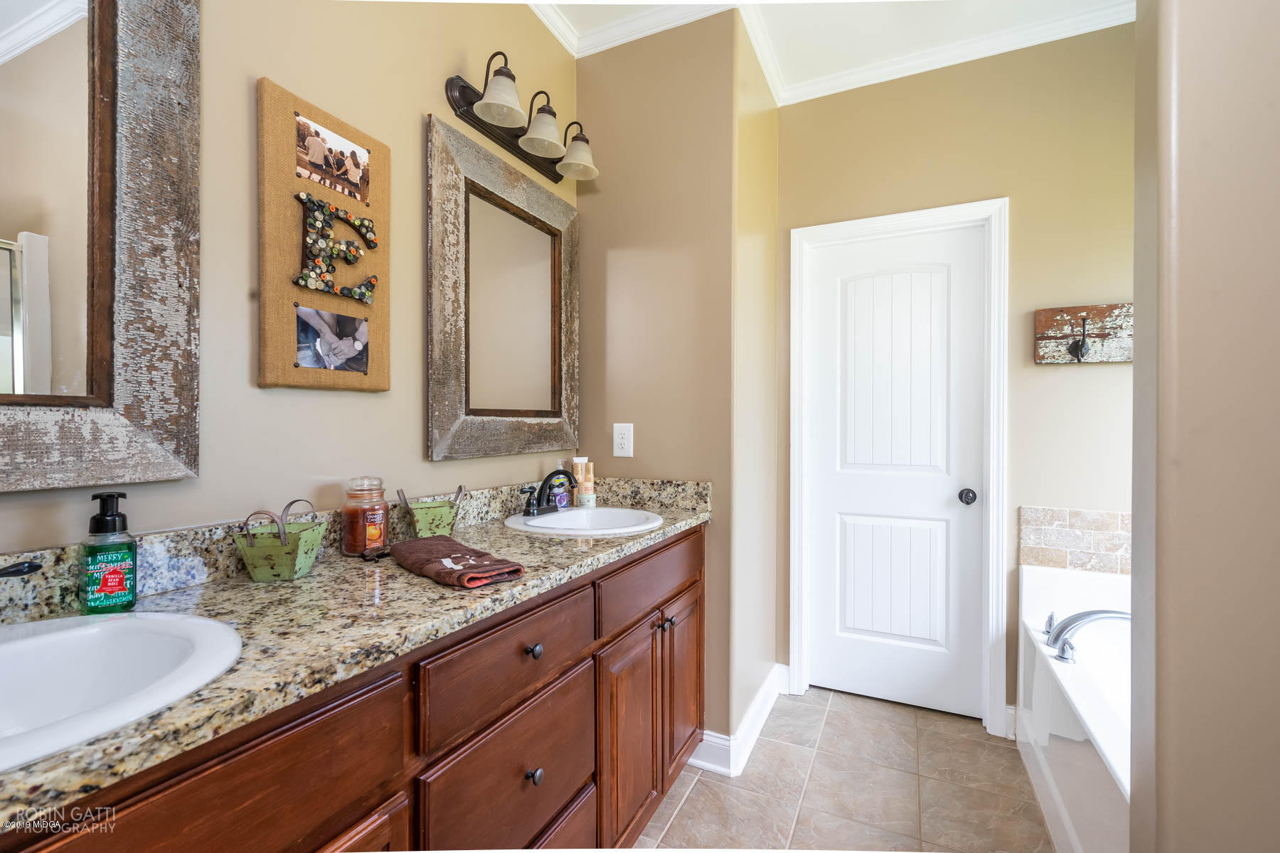 125 Rivers Edge Drive Forsyth, GA 31029 - Photo 14 of 21 a bathroom with a granite countertop sink and a mirror