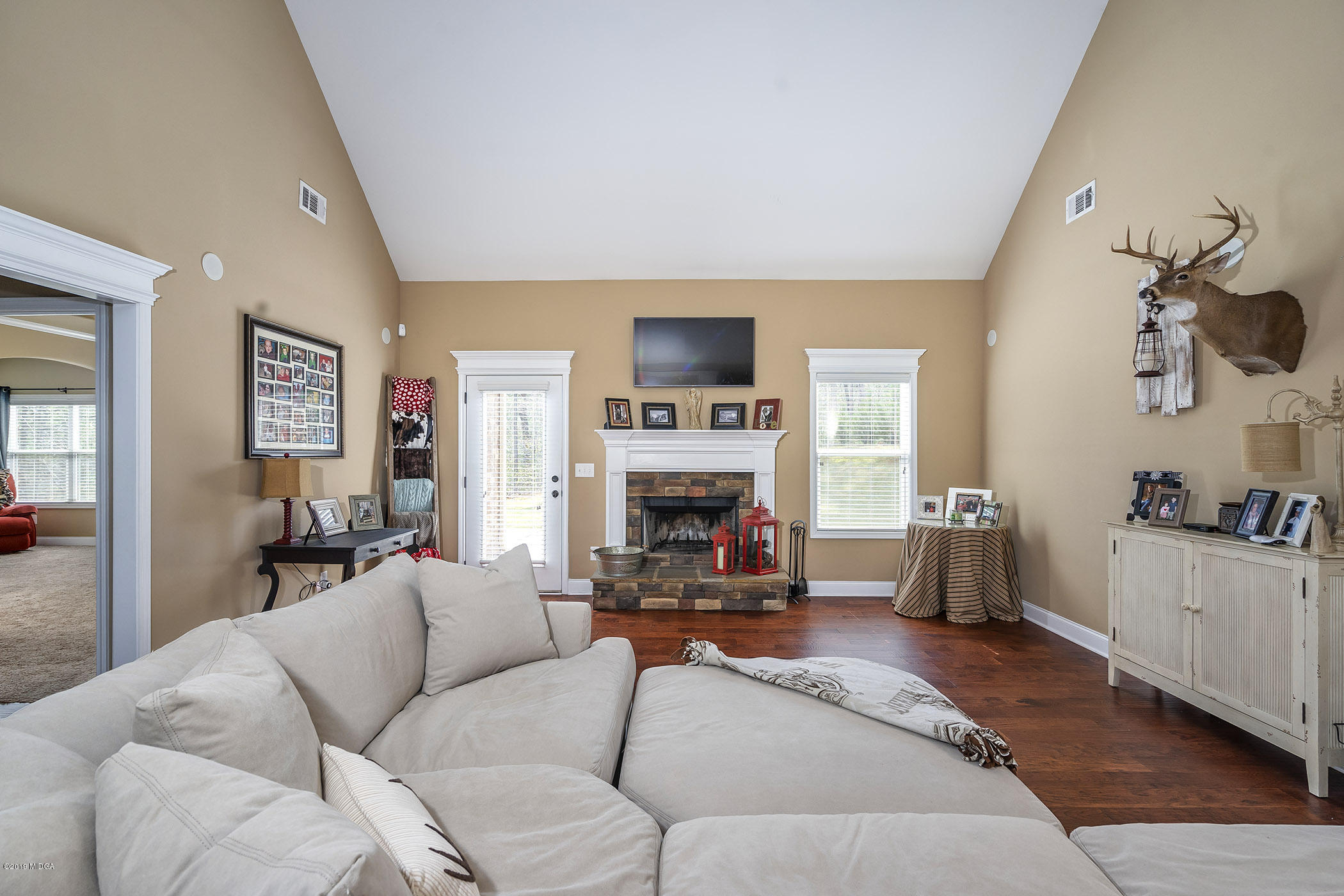 125 Rivers Edge Drive Forsyth, GA 31029 - Photo 6 of 21 a living room with furniture a fireplace and kitchen view