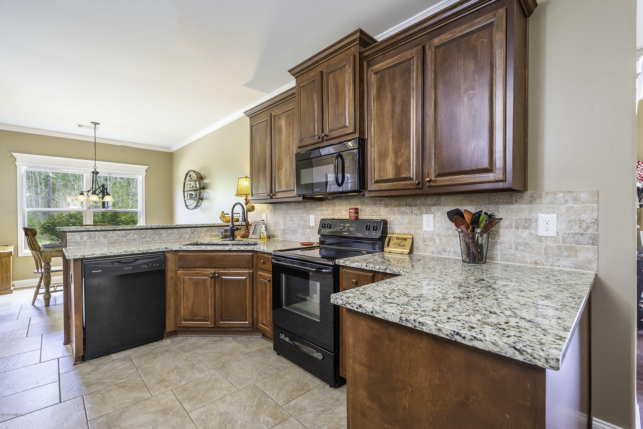 125 Rivers Edge Drive Forsyth, GA 31029 - Photo 7 of 21 a kitchen with stainless steel appliances granite countertop a stove sink and cabinets