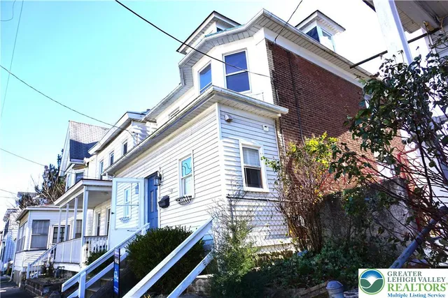 a view of a house with a small yard