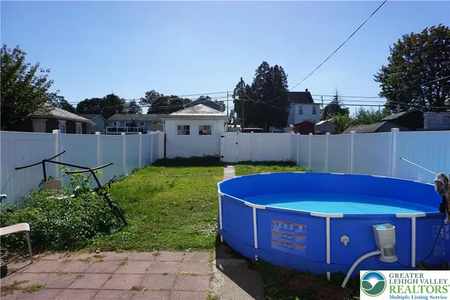 a view of a chairs and table in the backyard