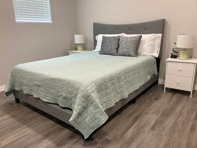 a bedroom with a bed and a window