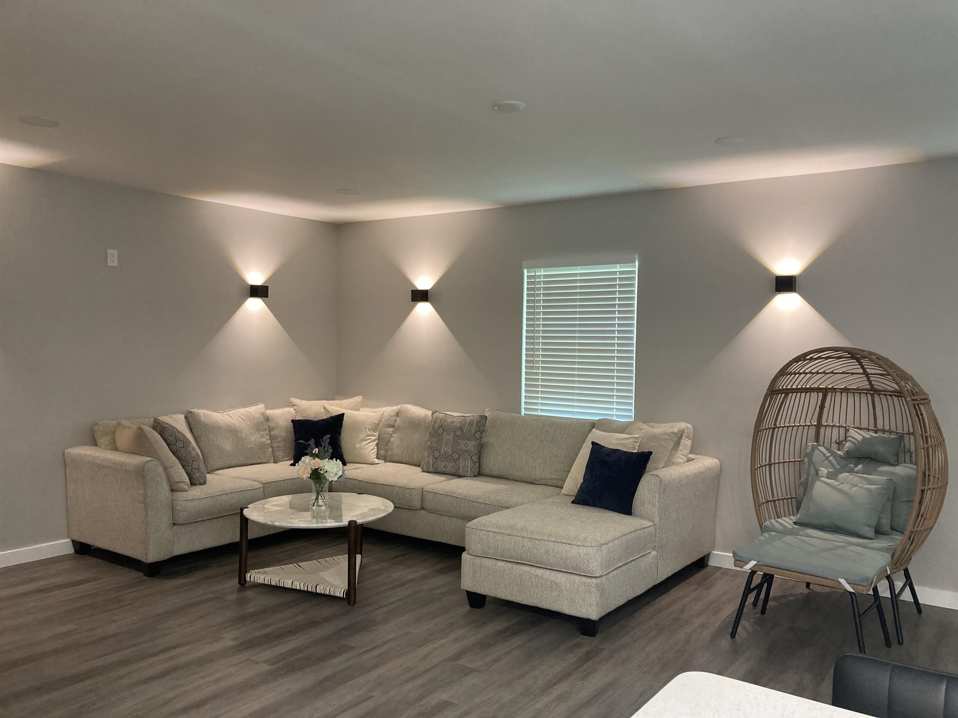 a living room with furniture and a potted plant