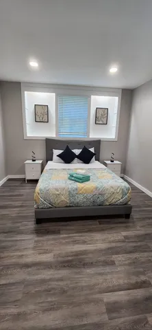 a large bed sitting in a bedroom next to a lamp