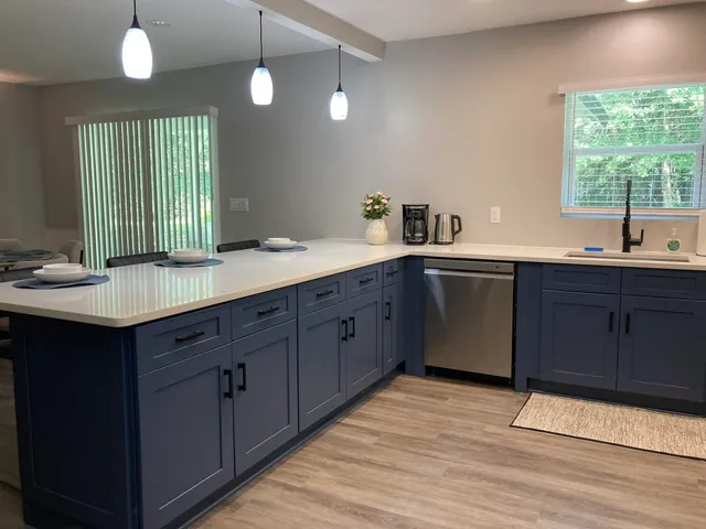a kitchen with a sink stove and cabinets