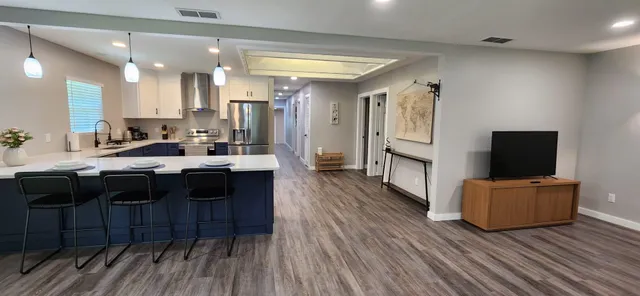 a kitchen with a refrigerator sink and cabinets