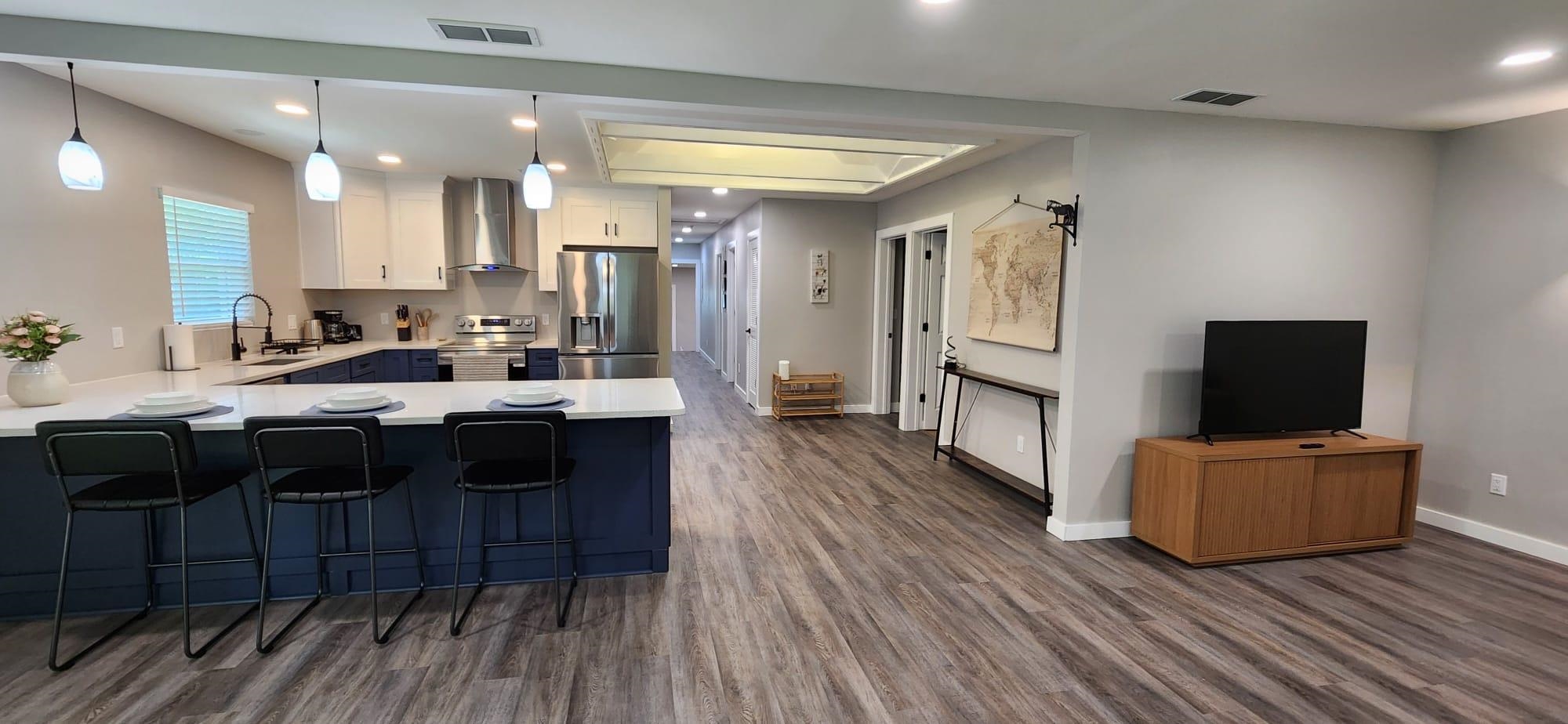 5200 Choctaw Street St. Augustine, FL 32092 - Photo 9 of 29 a living room with stainless steel appliances granite countertop furniture wooden floor a fireplace and a kitchen view