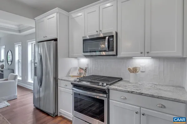 a kitchen with granite countertop cabinets and steel stainless steel appliances