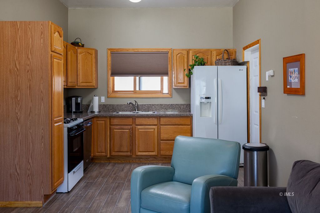 400 Dominy Road Lone Pine, CA 93545 - Photo 23 of 33 a kitchen with stainless steel appliances granite countertop a refrigerator and a stove top oven