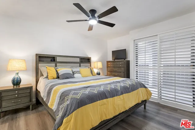 a bed sitting in a bedroom and night stand