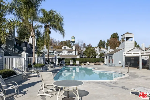 a view of a house with swimming pool and sitting area