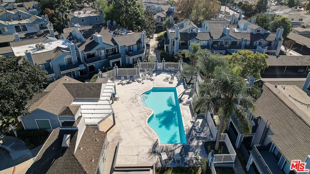 an aerial view of multiple houses with yard