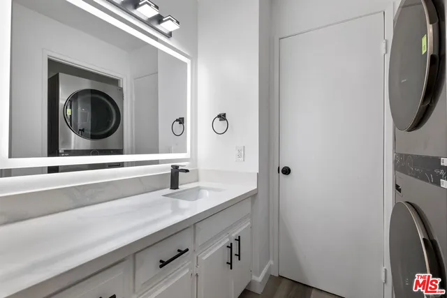 a bathroom with a sink a mirror and vanity