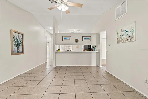 a view of kitchen with cabinets and window