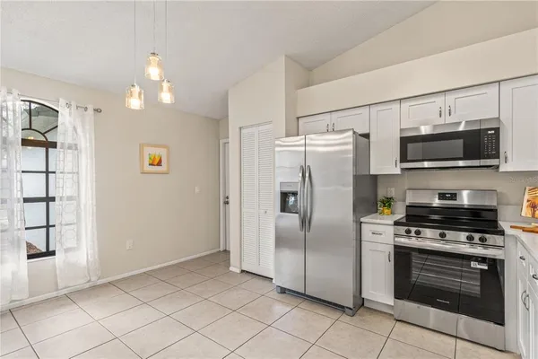 a kitchen with stainless steel appliances a refrigerator stove and microwave