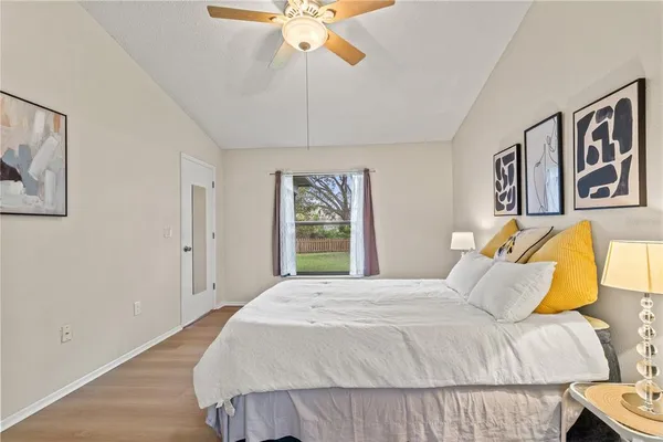 a bedroom with a bed and a painting on the wall