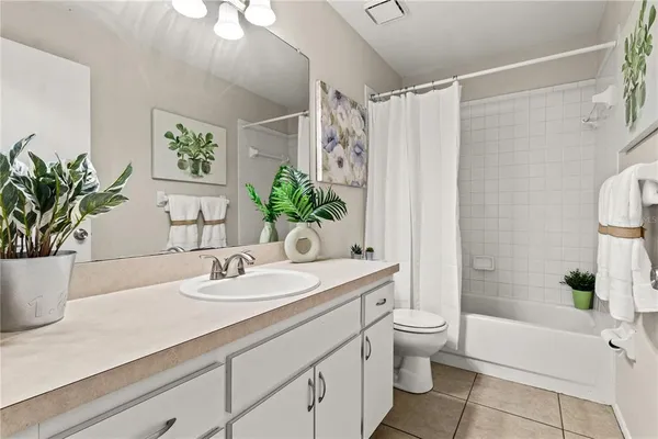 a bathroom with a granite countertop sink a toilet and shower