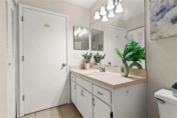 a bathroom with a sink vanity granite and a mirror