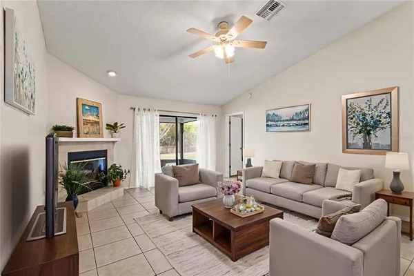 a living room with furniture a fireplace and a flat screen tv