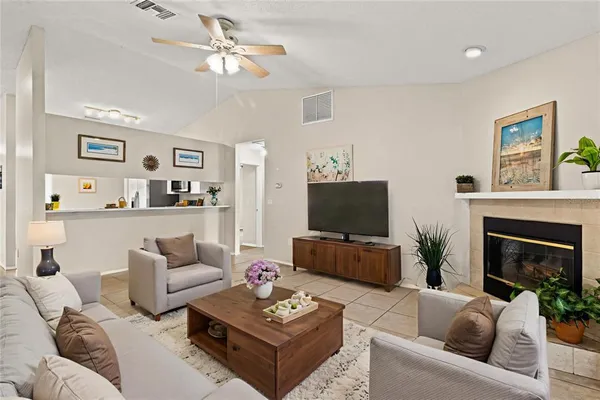 a living room with furniture a fireplace and a flat screen tv