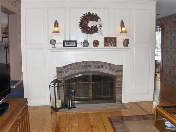 142 Hubbardston Road Princeton, MA 01541 - Photo 10 of 30 a living room with a fireplace and a flat screen tv