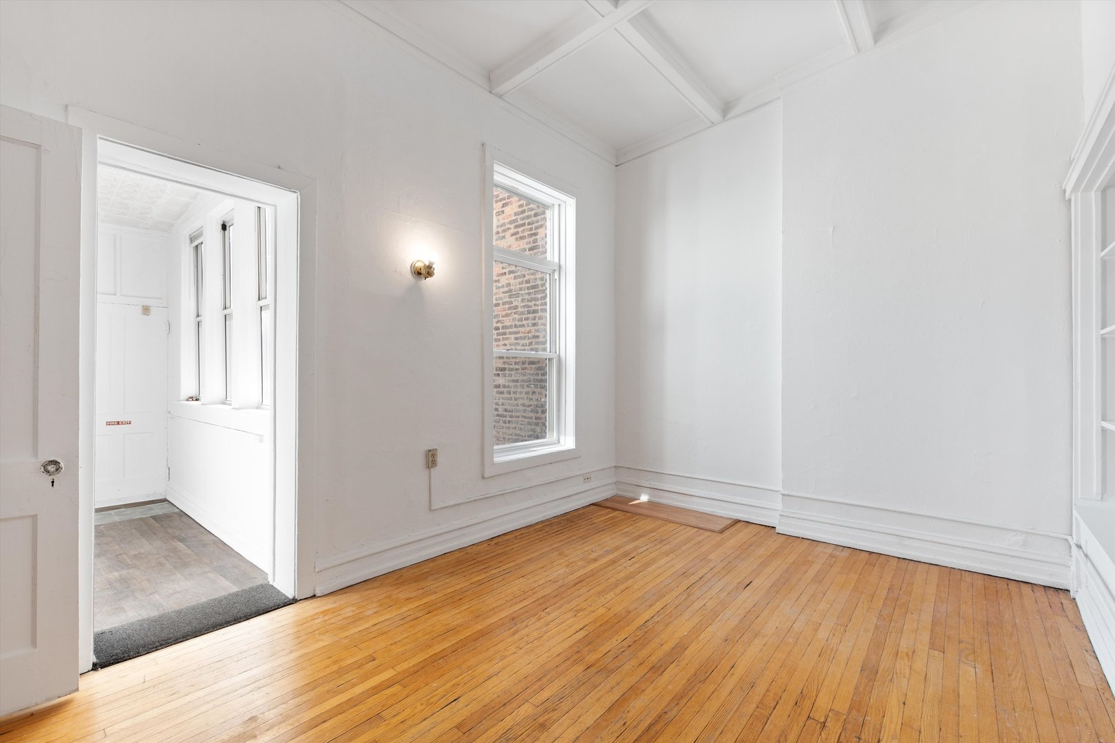 1239 North Dearborn Street Chicago, IL 60610 - Photo 11 of 30 an empty room with wooden floor and windows