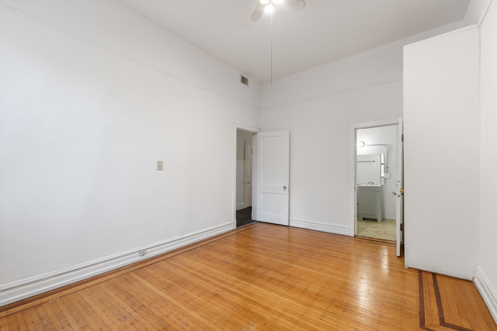 1239 North Dearborn Street Chicago, IL 60610 - Photo 12 of 30 a view of an empty room with wooden floor