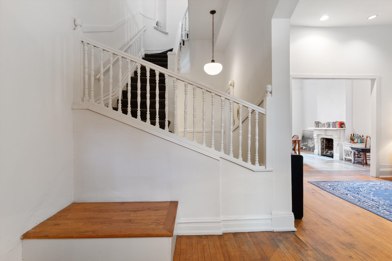 1239 North Dearborn Street Chicago, IL 60610 - Photo 3 of 30 a view of staircase with lots of frames and wooden floor