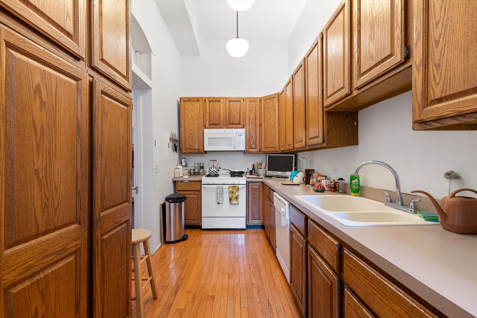 1239 North Dearborn Street Chicago, IL 60610 - Photo 6 of 30 a kitchen with stainless steel appliances granite countertop a sink dishwasher stove refrigerator and cabinets