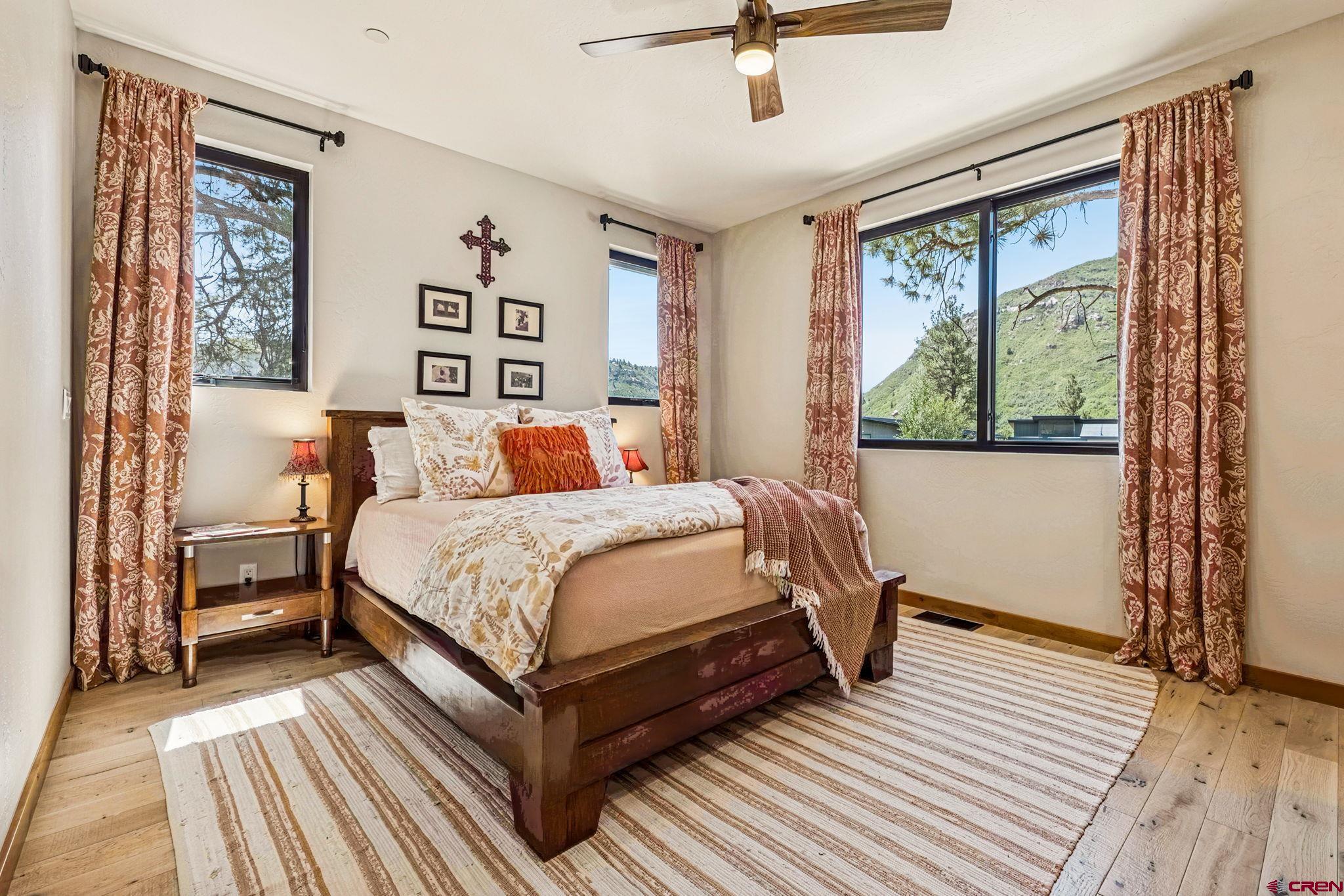 1022 Twin Buttes Avenue Durango, CO 81301 - Photo 16 of 45 a bedroom with a large bed and a window