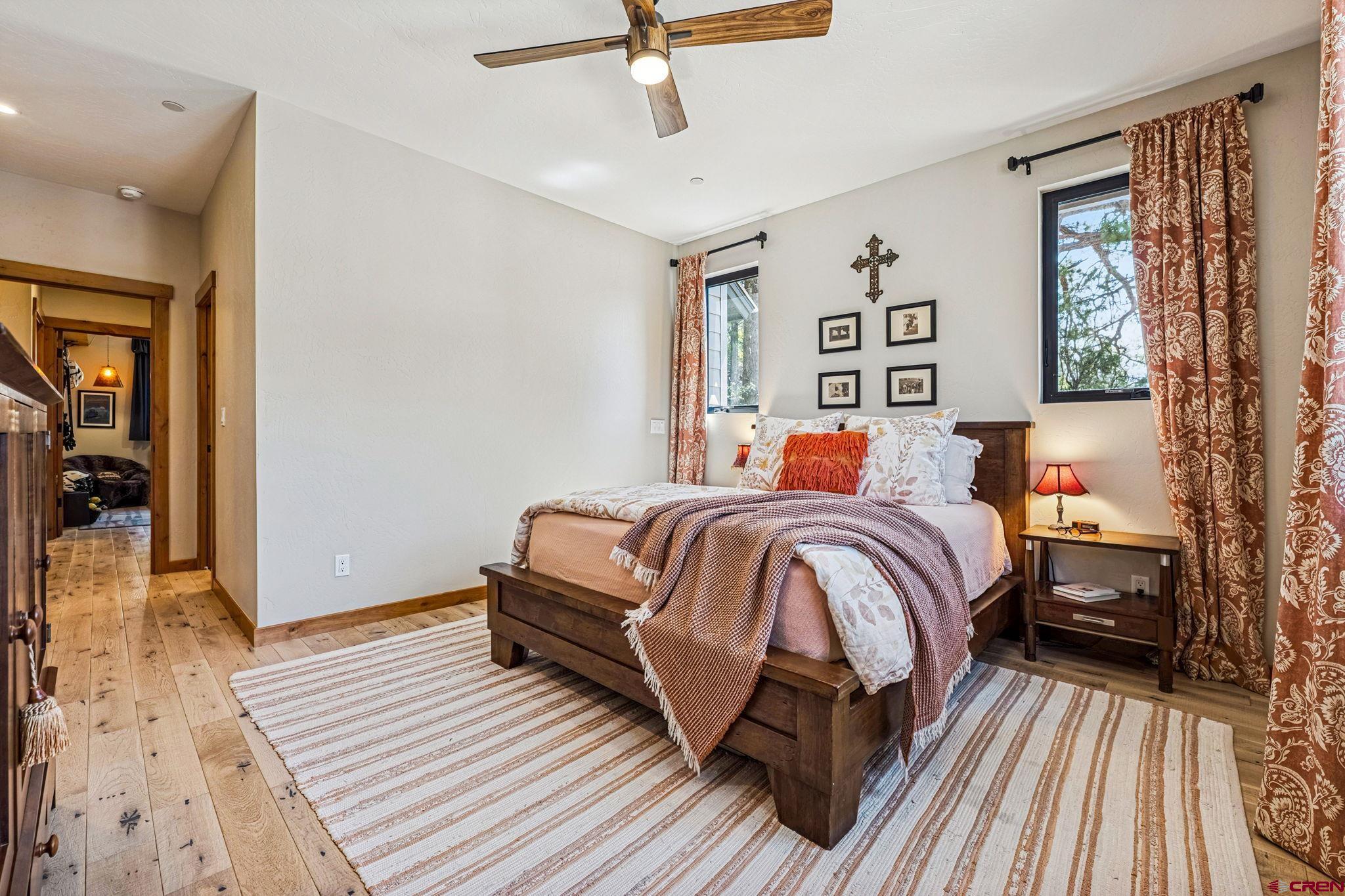 1022 Twin Buttes Avenue Durango, CO 81301 - Photo 17 of 45 a bedroom with a bed and wooden floor