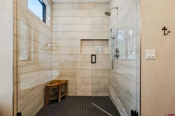 a bathroom with a bathtub and shower