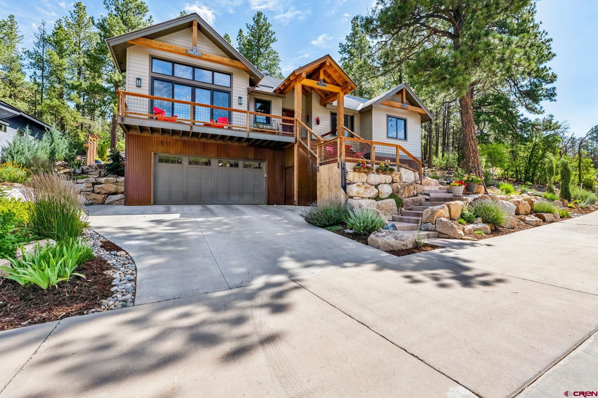 1022 Twin Buttes Avenue Durango, CO 81301 - Photo 2 of 45 a front view of a house with a yard and trees