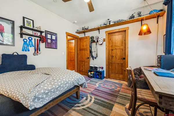 a living room with couches bookshelf and a flat screen tv