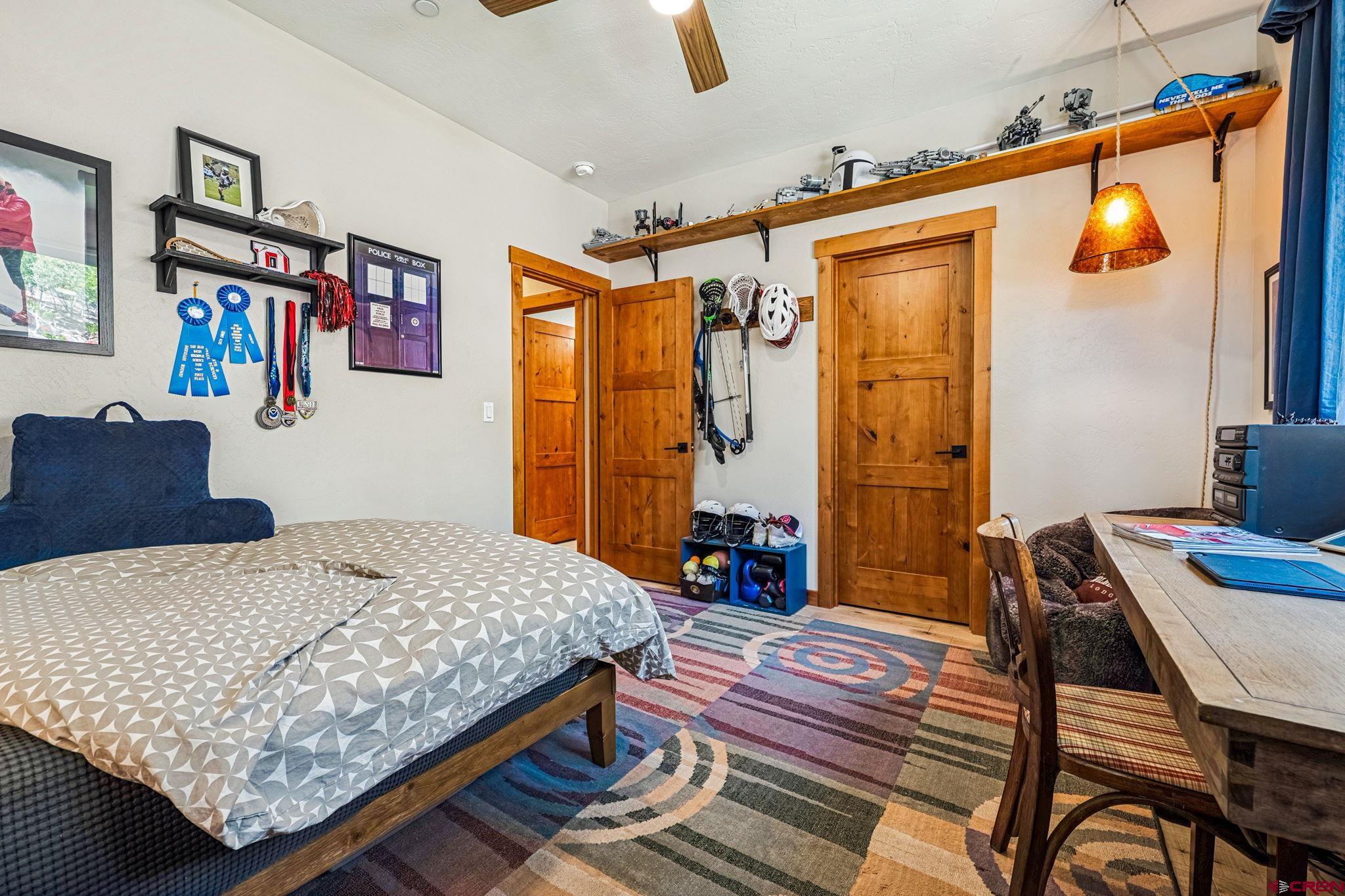 1022 Twin Buttes Avenue Durango, CO 81301 - Photo 21 of 45 a bedroom with a bed and a table in it