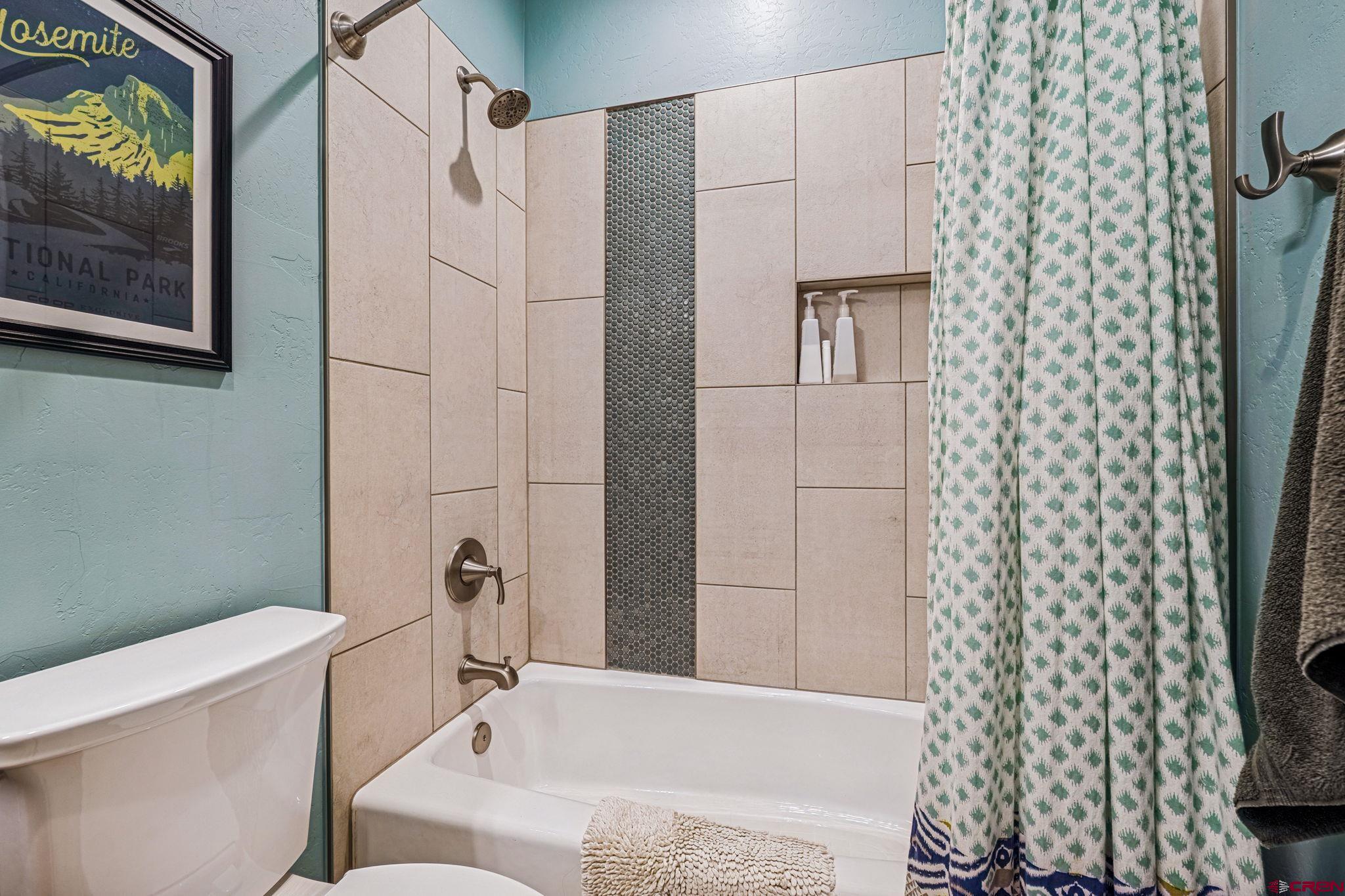 1022 Twin Buttes Avenue Durango, CO 81301 - Photo 23 of 45 a bathroom with a bathtub and shower