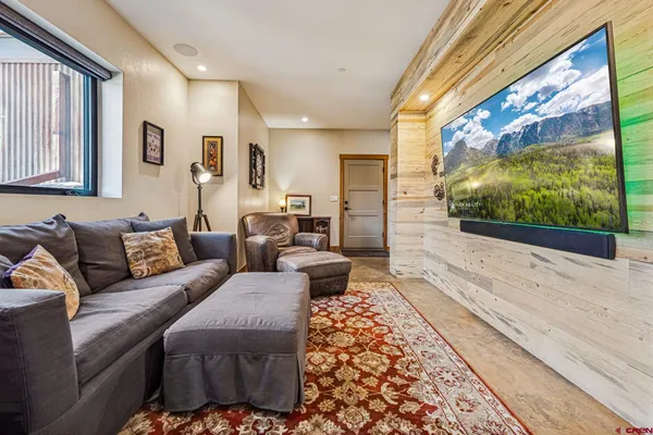 a view of front door with wooden floor and potted plant