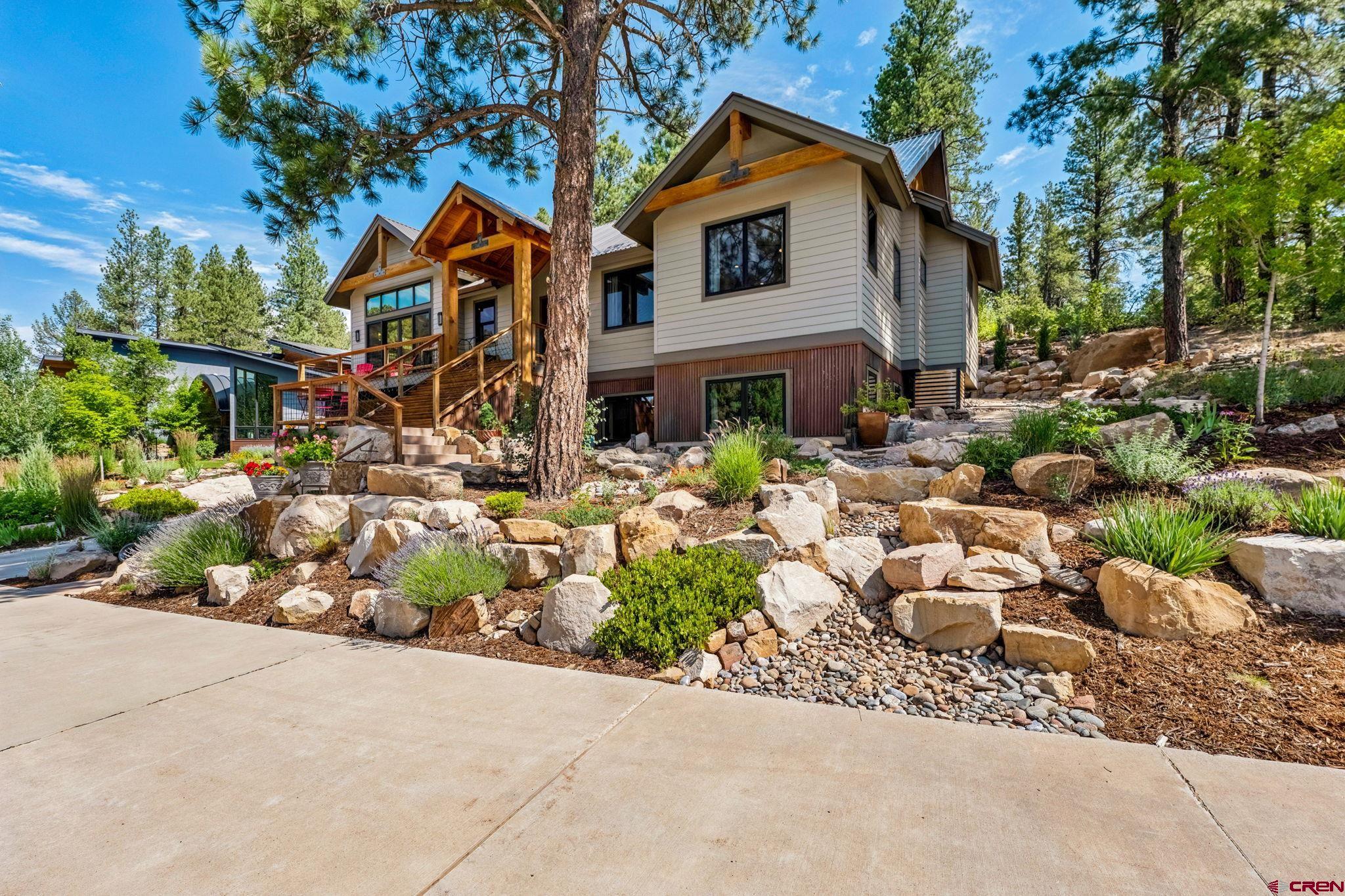1022 Twin Buttes Avenue Durango, CO 81301 - Photo 44 of 45 a front view of a house with a yard and a tree