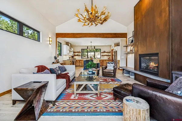 a kitchen with stainless steel appliances granite countertop a table chairs and a refrigerator