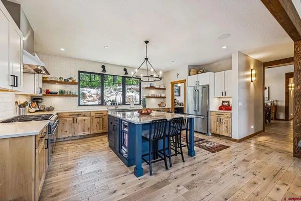 a kitchen with stainless steel appliances granite countertop a stove and refrigerator