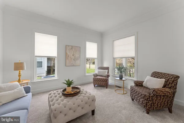 a living room with furniture fireplace and a large window