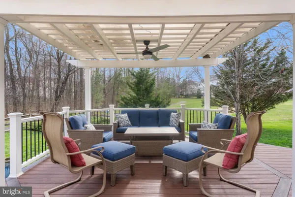 a view of a patio with table and chairs under an umbrella