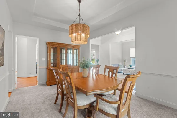 a kitchen with stainless steel appliances granite countertop a stove a sink dishwasher and a microwave oven with wooden cabinets