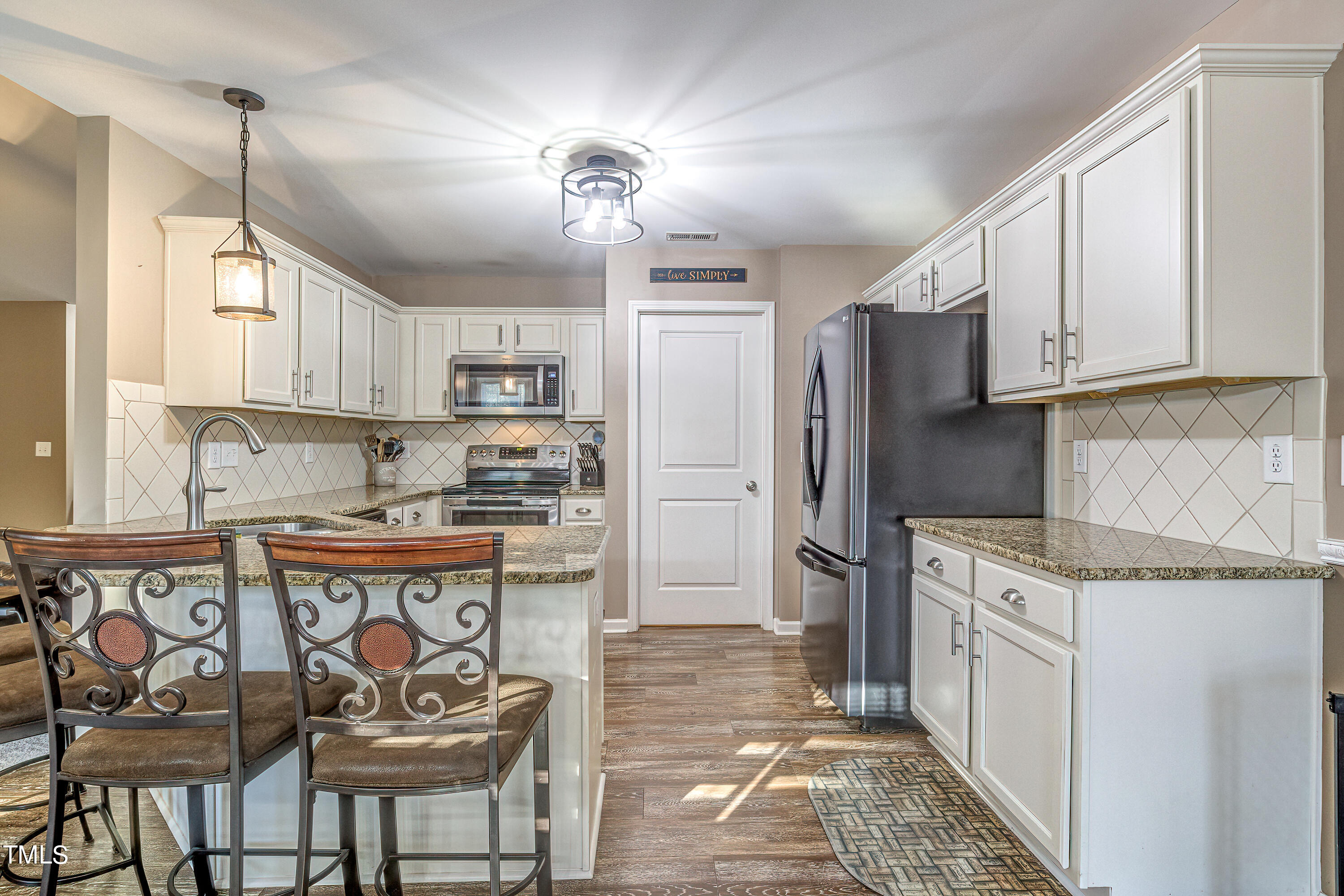 235 Highcroft Circle Benson, NC 27504 - Photo 11 of 25 a kitchen with stainless steel appliances granite countertop a refrigerator and a stove top oven