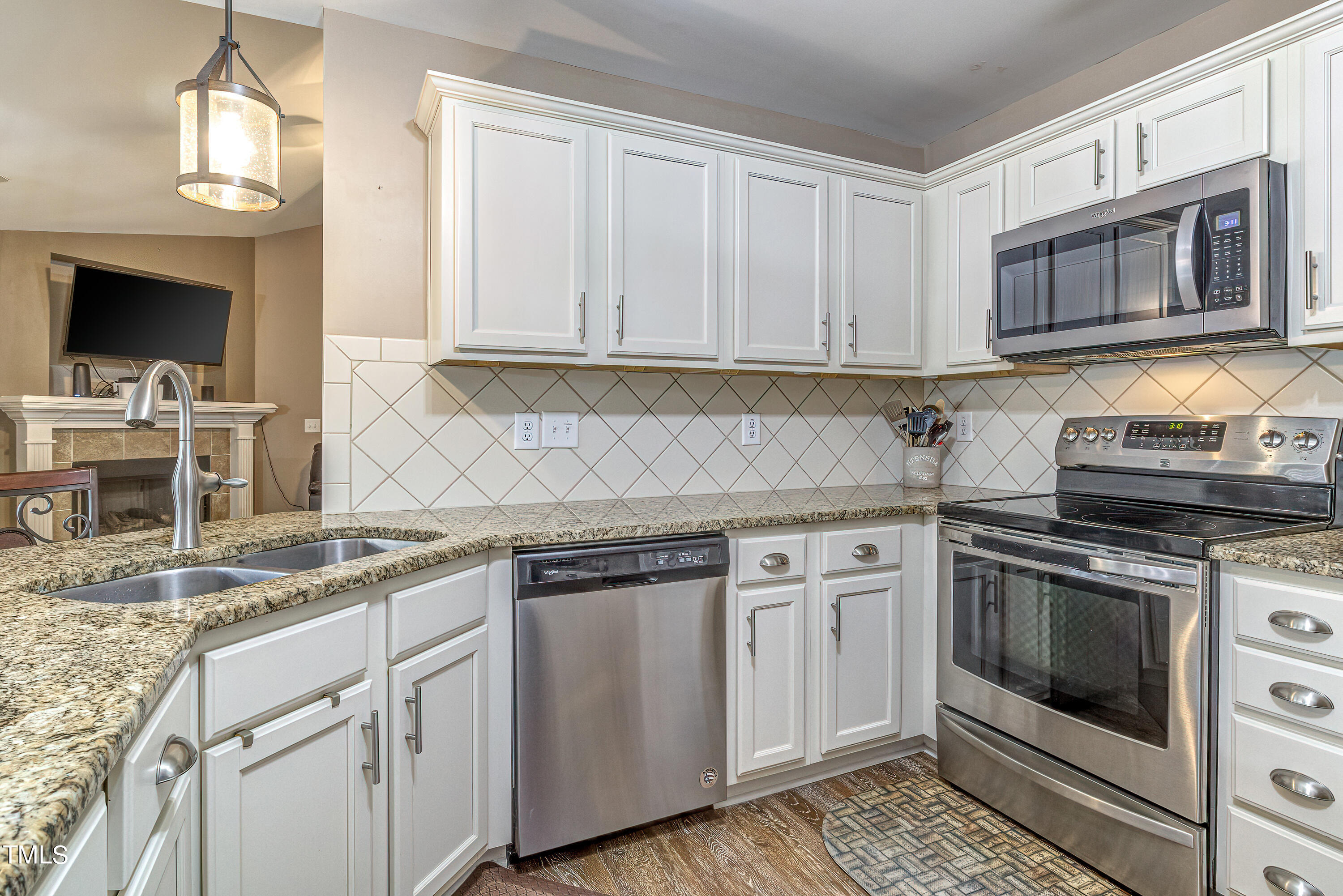 235 Highcroft Circle Benson, NC 27504 - Photo 12 of 25 a kitchen with stainless steel appliances granite countertop a stove a sink and a microwave