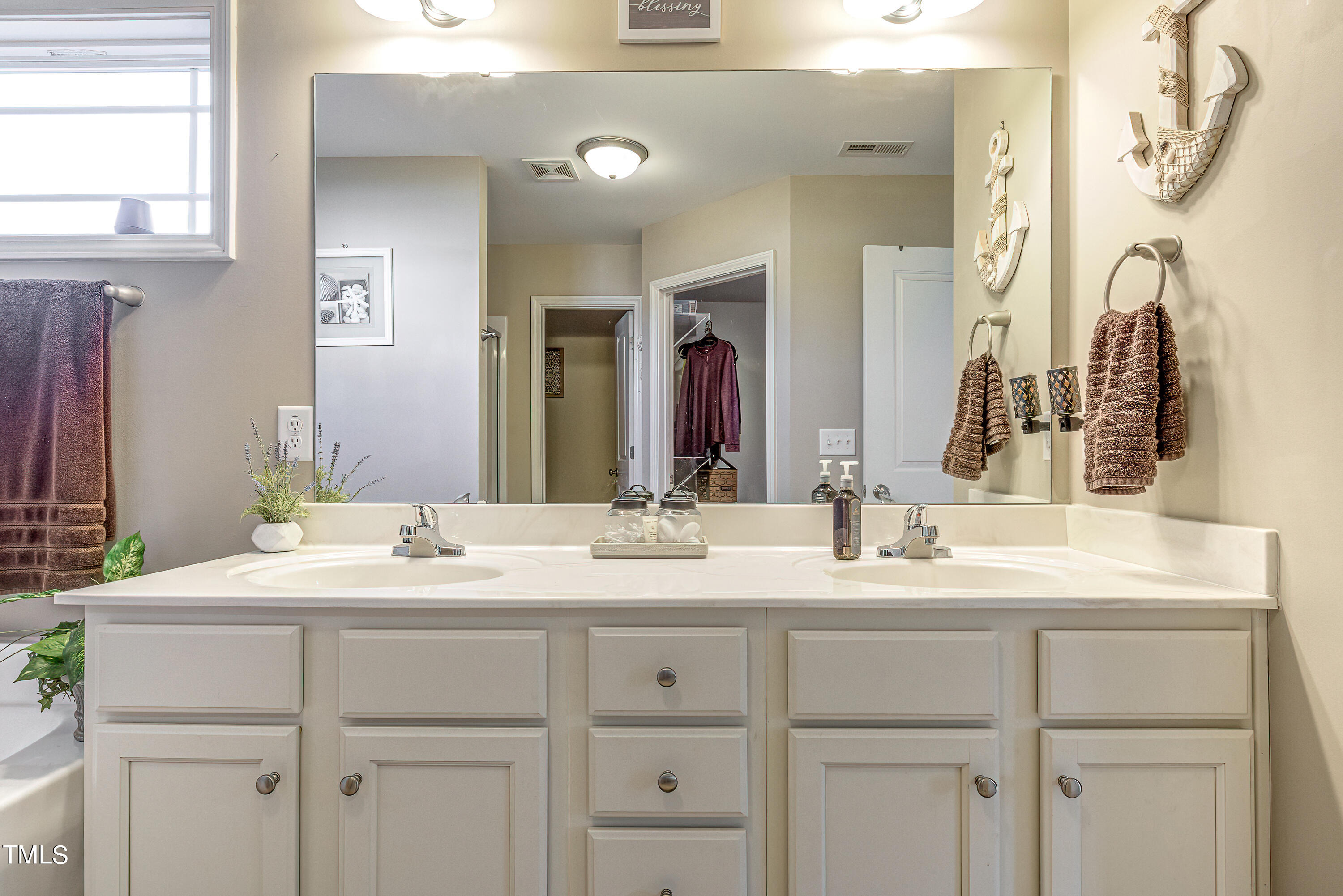 235 Highcroft Circle Benson, NC 27504 - Photo 16 of 25 a bathroom with a sink vanity and a mirror