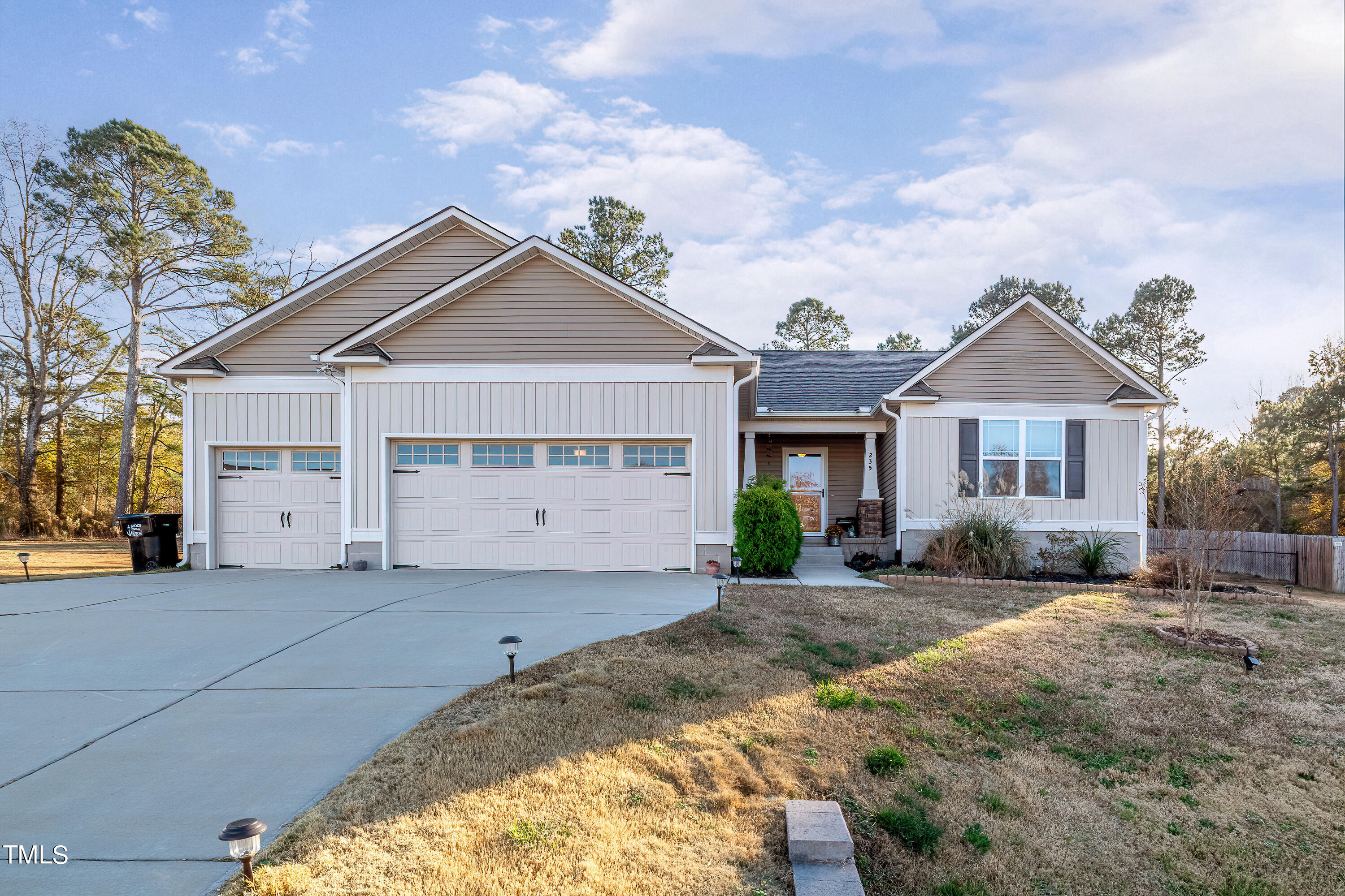 235 Highcroft Circle Benson, NC 27504 - Photo 2 of 25 a front view of a house with a yard and garage