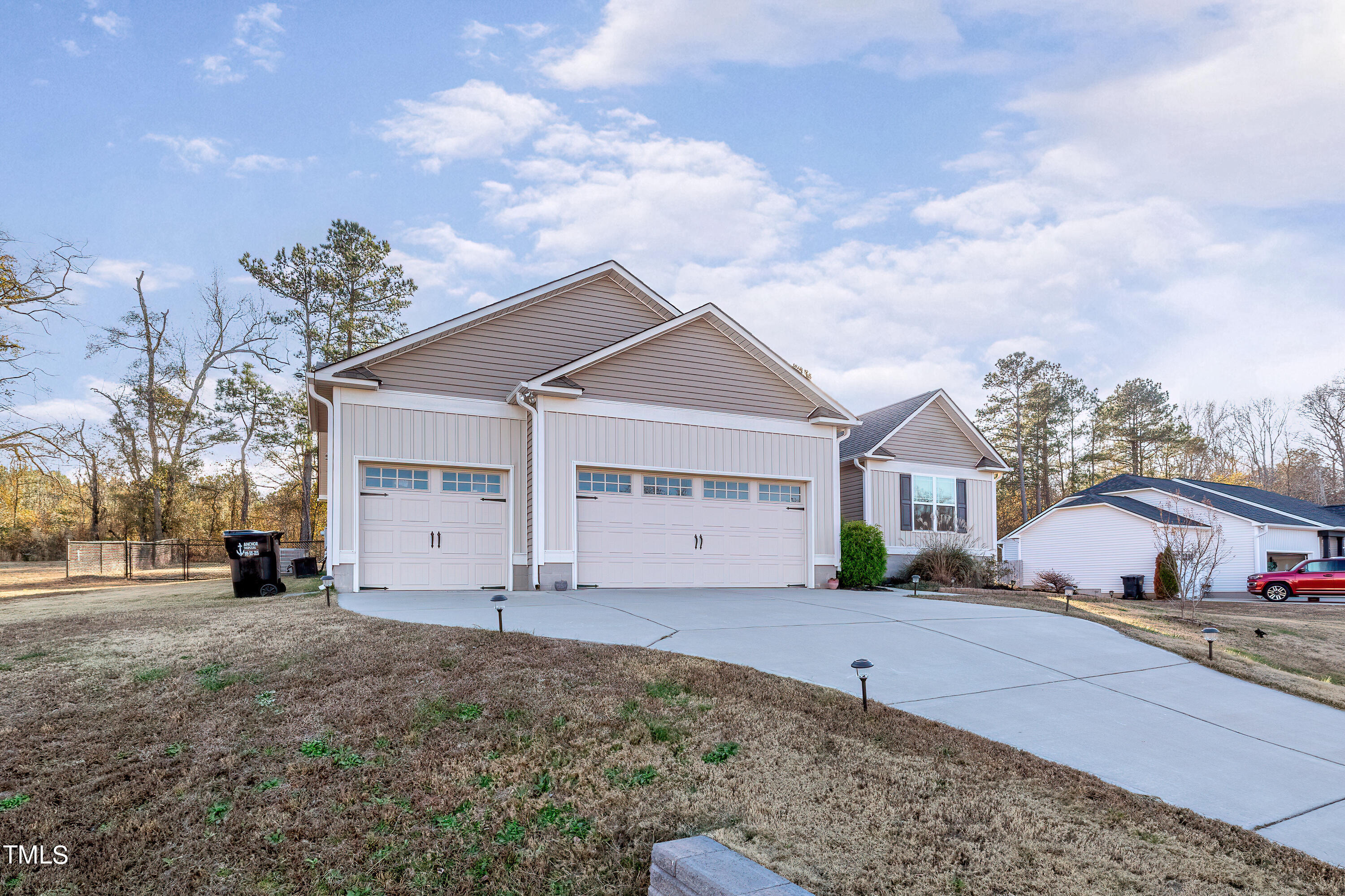 235 Highcroft Circle Benson, NC 27504 - Photo 3 of 25 a front view of a house with a yard and garage
