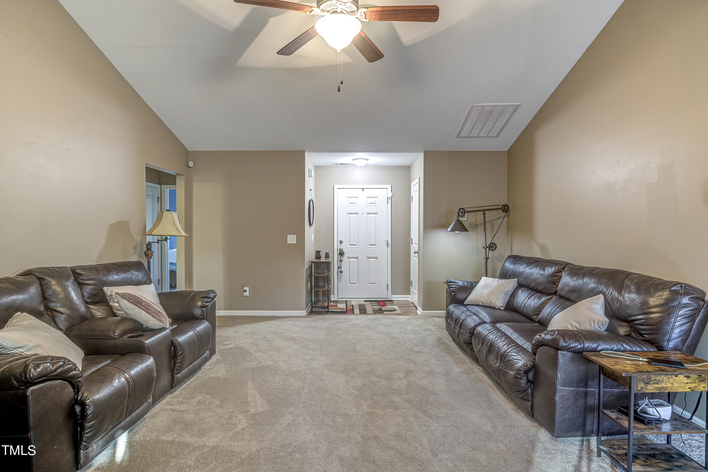 235 Highcroft Circle Benson, NC 27504 - Photo 8 of 25 a living room with furniture and a chandelier