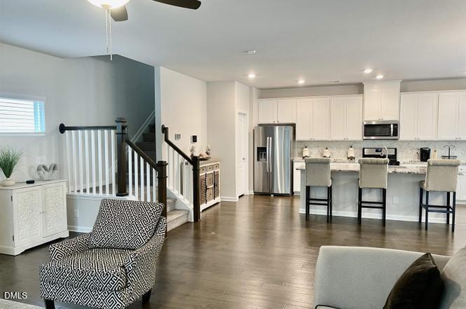 1807 Wrenn Road Durham, NC 27703 - Photo 12 of 43 a living room with furniture and kitchen view with wooden floor